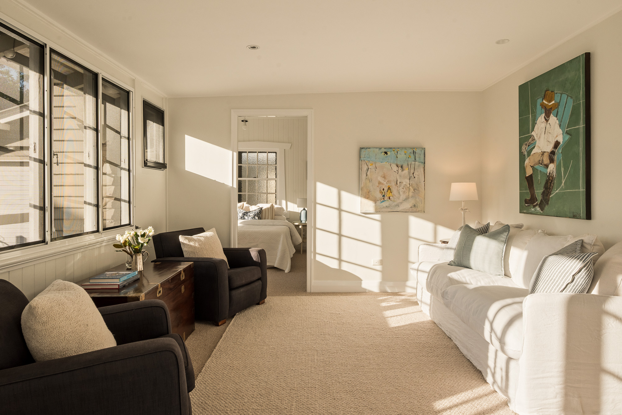 Sunroom adjoining a bedroom with warm afternoon light