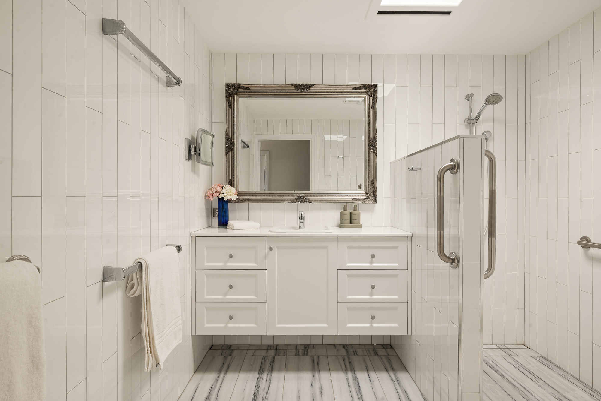 White ensuite with walk-in shower and marble floor