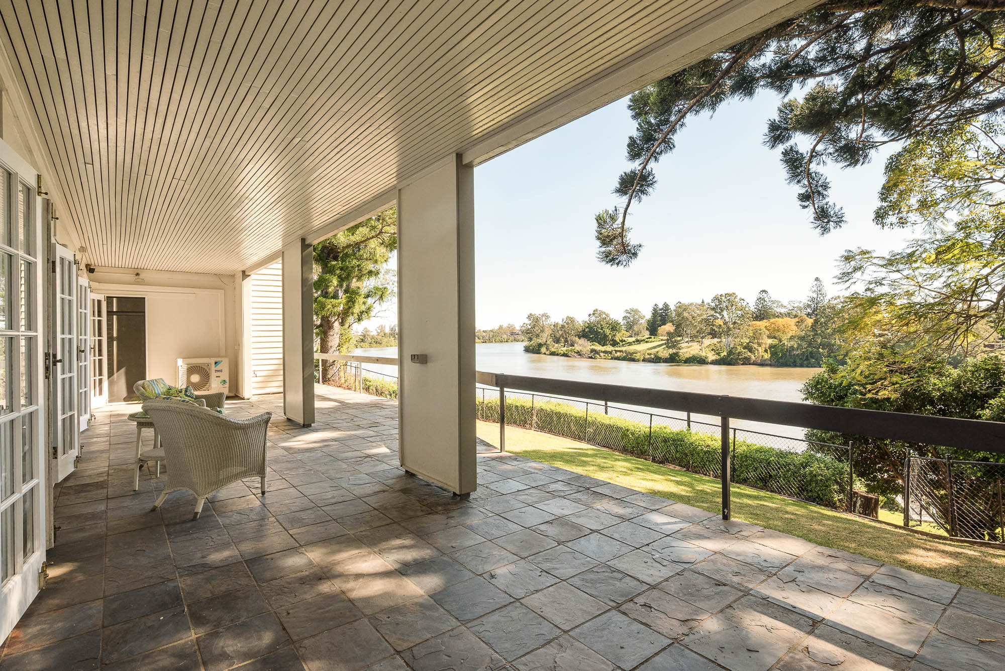Wide covered verandah overlooking the Brisbane River